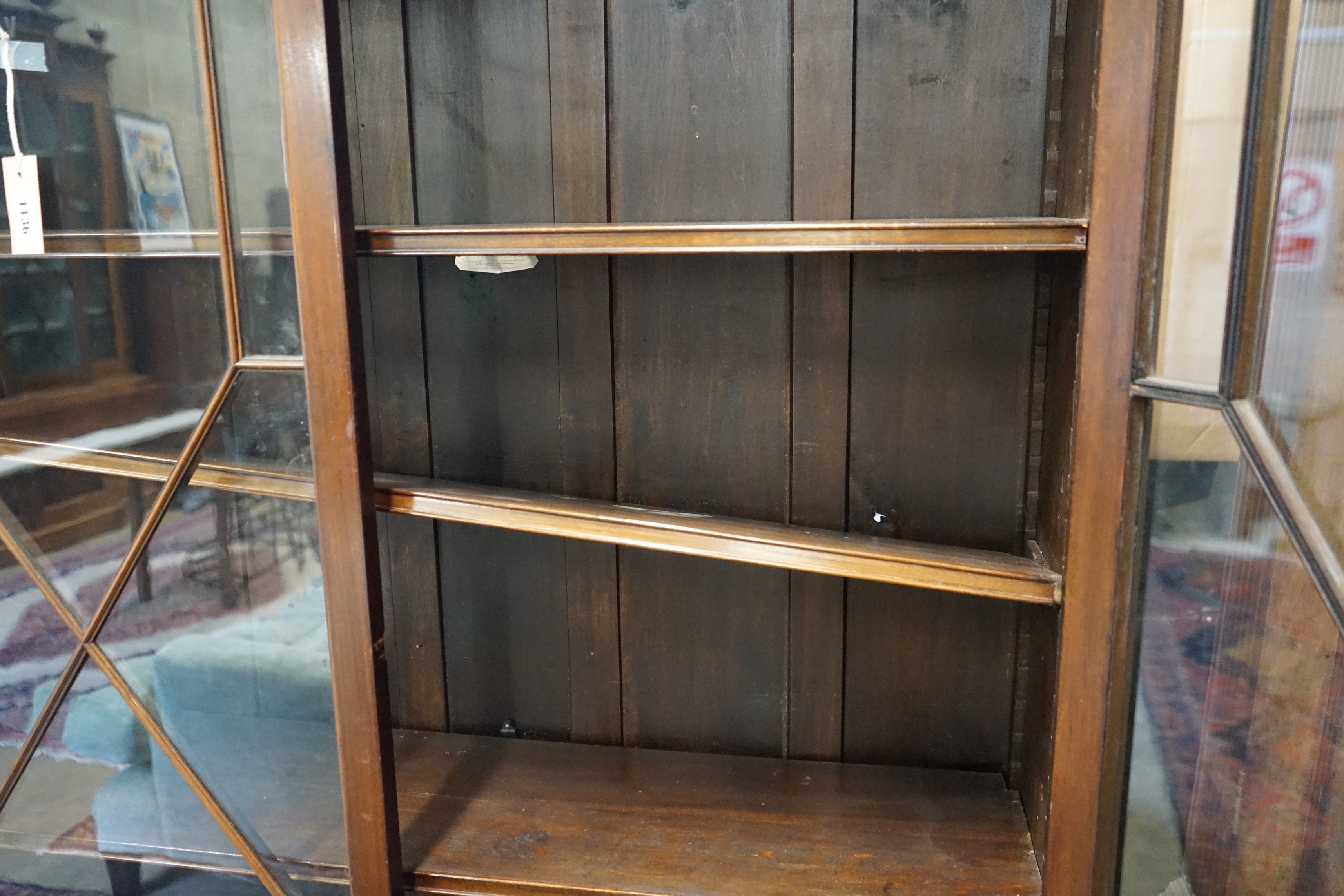 A 1920's Chippendale revival mahogany bookcase, length 115cm, depth 34cm, height 202cm